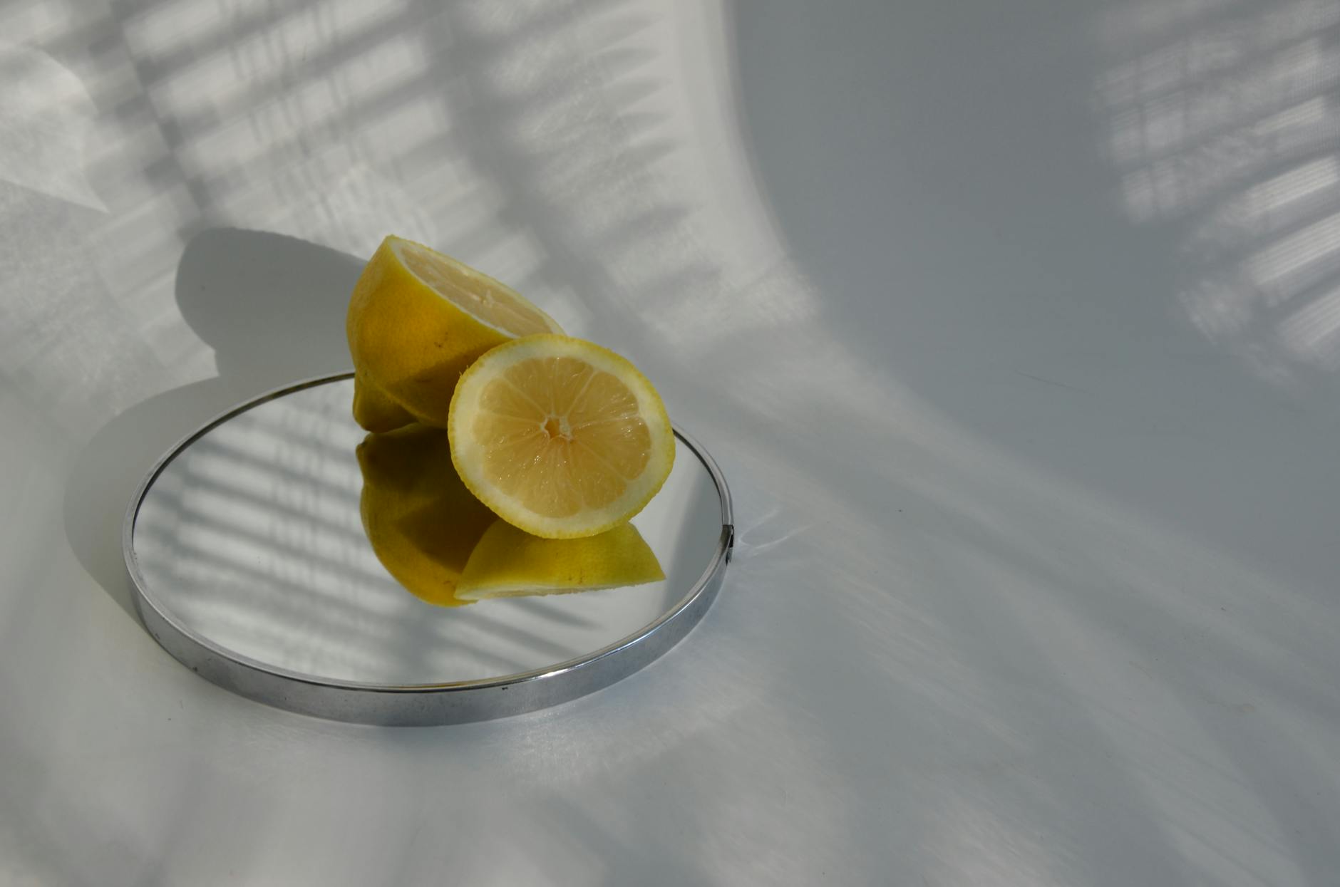 Sliced lemons on a reflective surface, representing the sensory buildup of arousal.